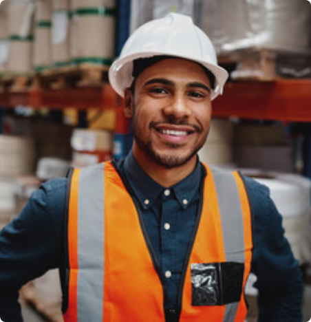 photo d'un homme portant un casque de protection blanc et une veste de visibilité orange.